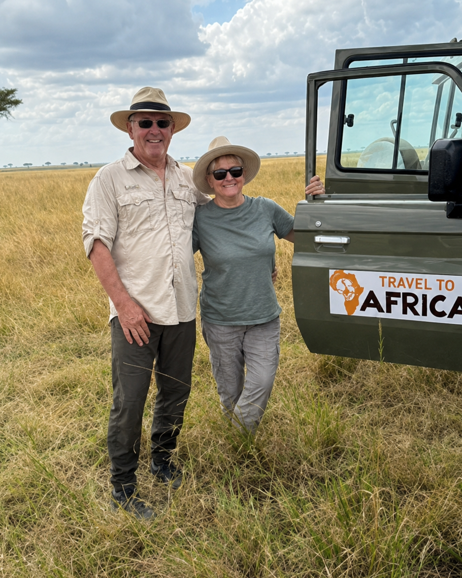 Australian travellers beside a Travel to Africa safari vehicle on the Serengeti plains